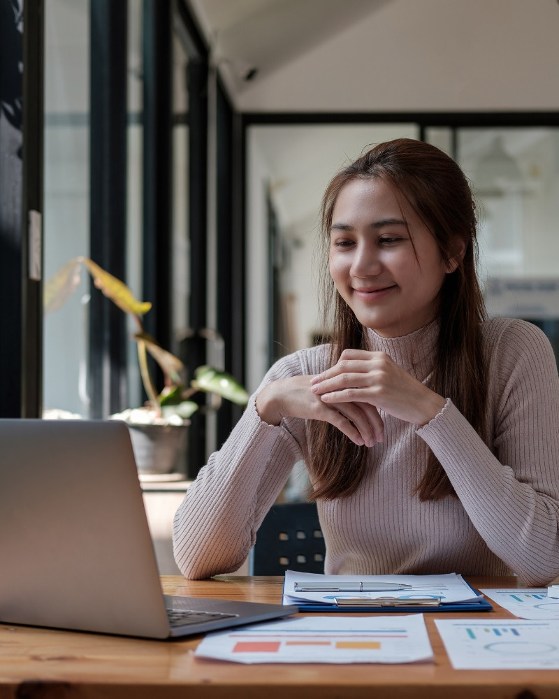 Smiling woman on a laptop video call for online group therapy